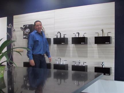 Ken's Plumbing & Heating owner Ken Rasso with Kohler faucets